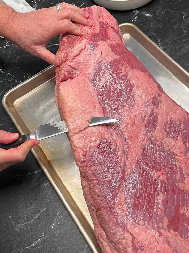 Trimming the deckle out of a brisket.