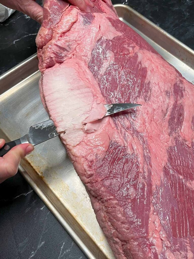 Trimming the deckle out of the brisket.