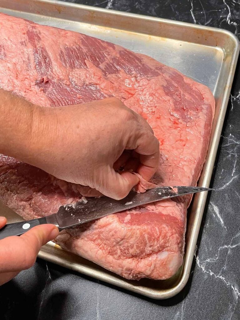 trimming fat off of a brisket.