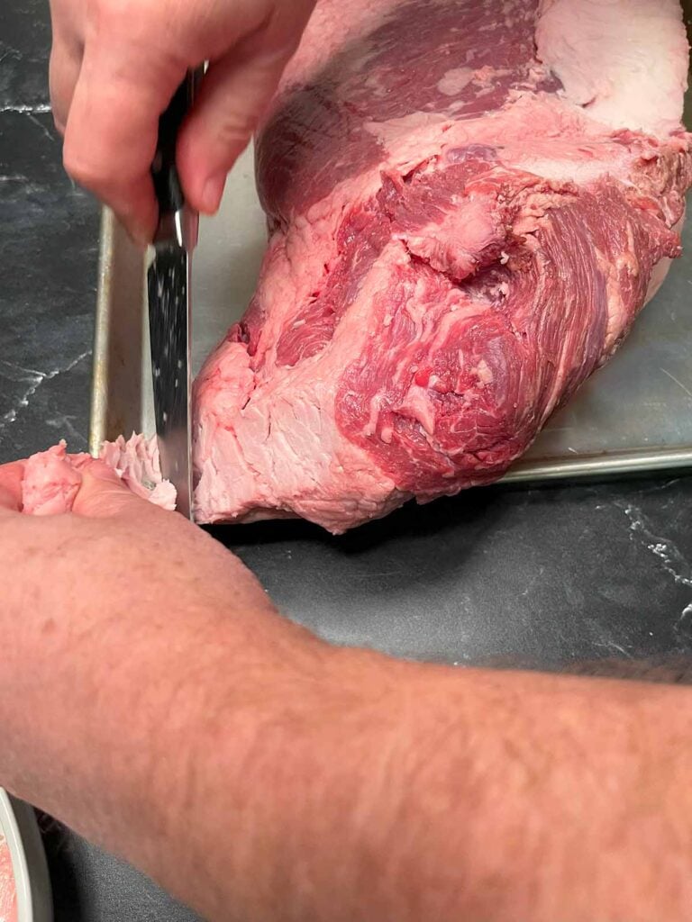 Trimming fat off of a brisket.