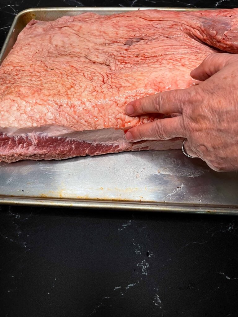 Showing where the big sections of fat is on a brisket.