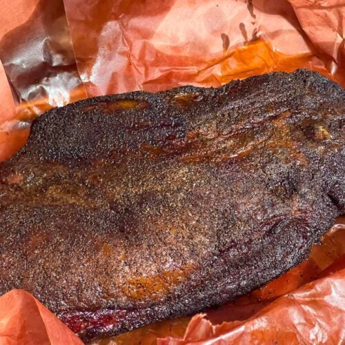 A smoked brisket with the butcher paper unwrapped.
