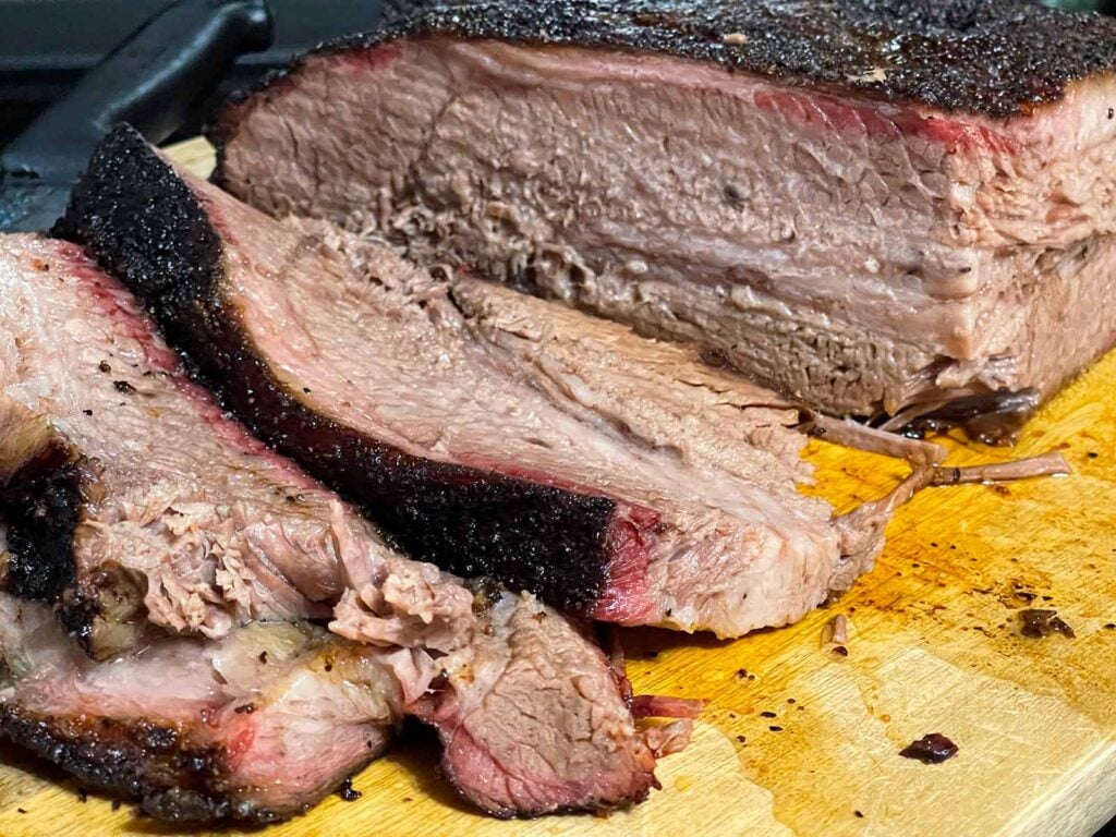 Slices of brisket from the point side on a cutting board.