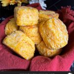 Sweet potato biscuits in a red lined cloth basket.