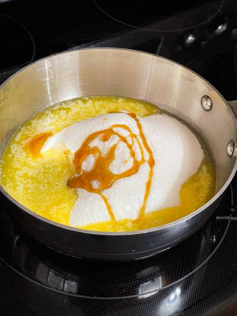 Toffee ingredients in a saucepan on the stove burner.