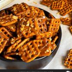 Butter toffee pretzels in a dark bowl on the baking sheet.