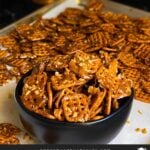 Butter toffee pretzels in a dark bowl on the baking sheet.