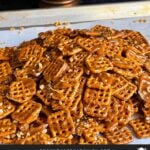 Butter toffee pretzels on a parchment paper lined baking sheet.