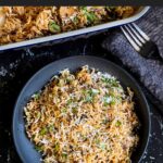 Basmati rice risotto (stick of butter rice) in a casserole dish.