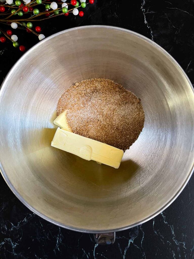 Chai sugar mixture in a metal mixing bowl with the room temperature butter.