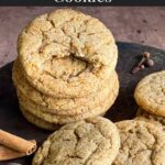 Chai sugar cookies stacked on an old metal cake pan.