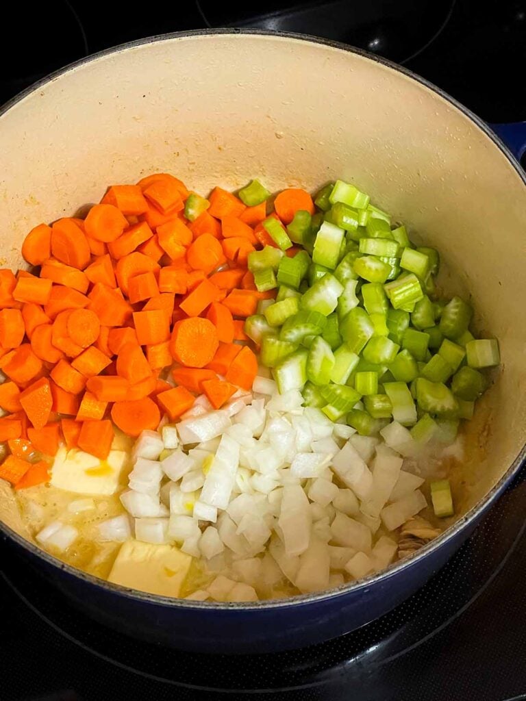 Onions, celery, and carrot in a dutch oven.