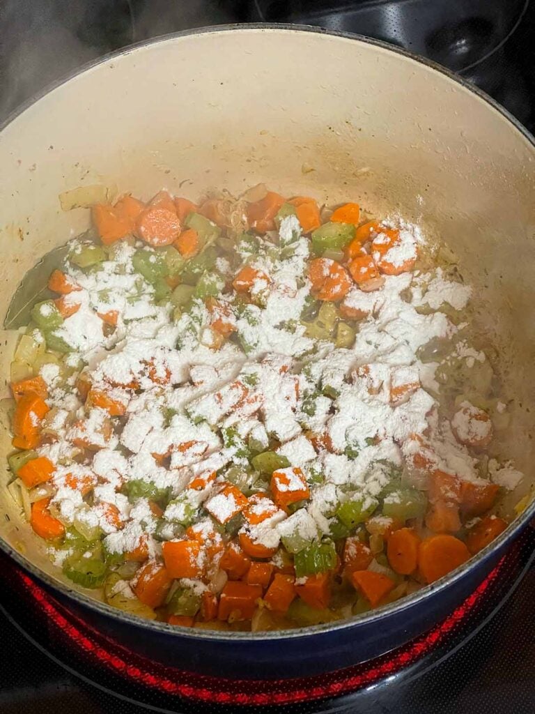 Making a roux with the cooked vegetables in a dutch oven.