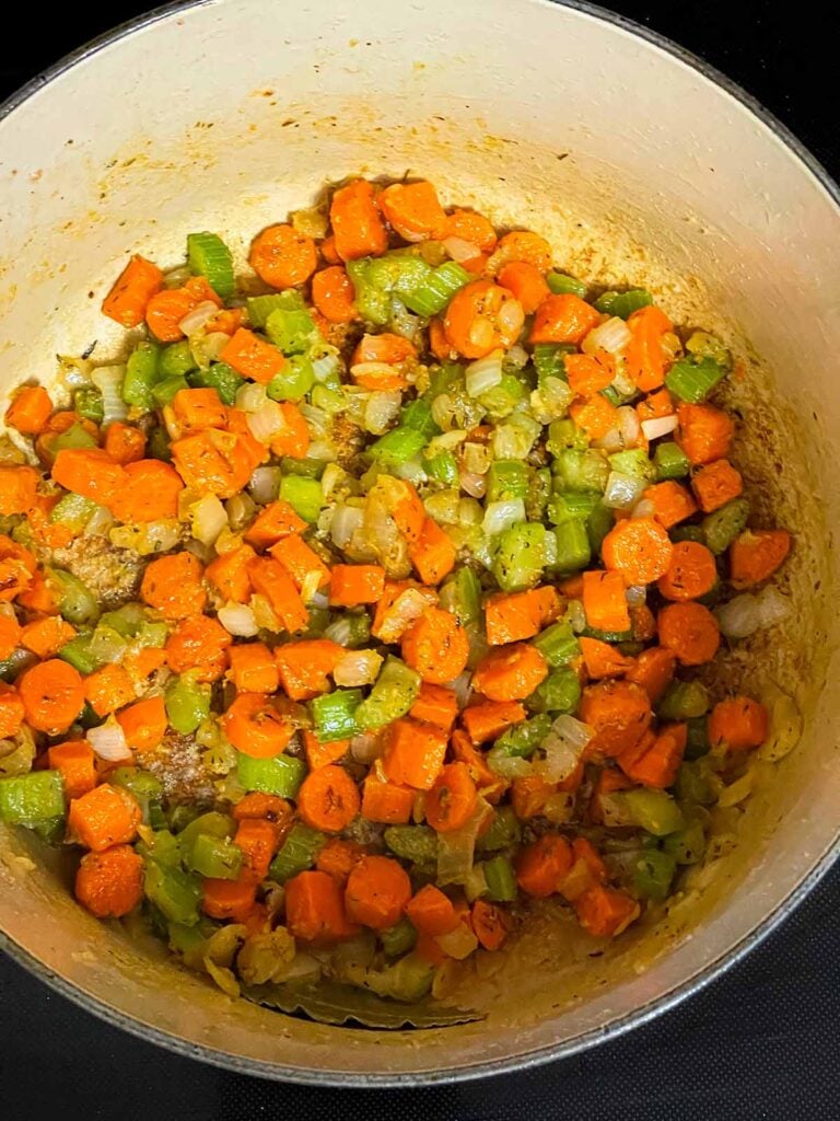 Cooked vegetables in a roux in a dutch oven.