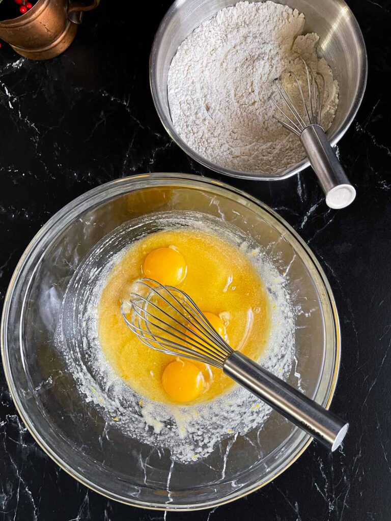 Eggs added to the wet ingredients for the cranberry pistachio biscotti.