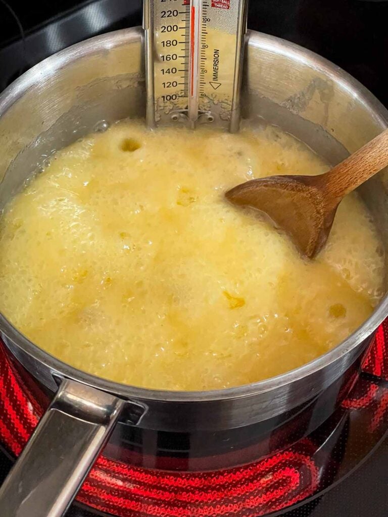 Eggnog fudge ingredients boiling in a saucepan.