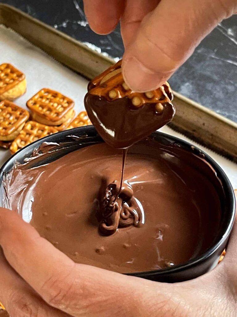 Peanut butter pretzel bite dipped into melted chocolate.