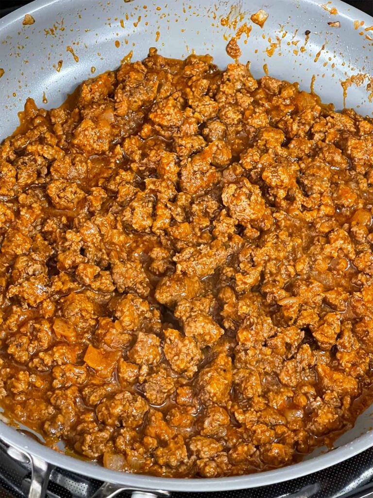 A sloppy joe mixture cooking in a skillet.
