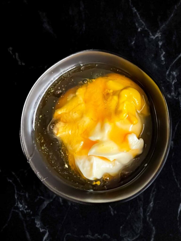 Honey mustard ingredients in a dark bowl.