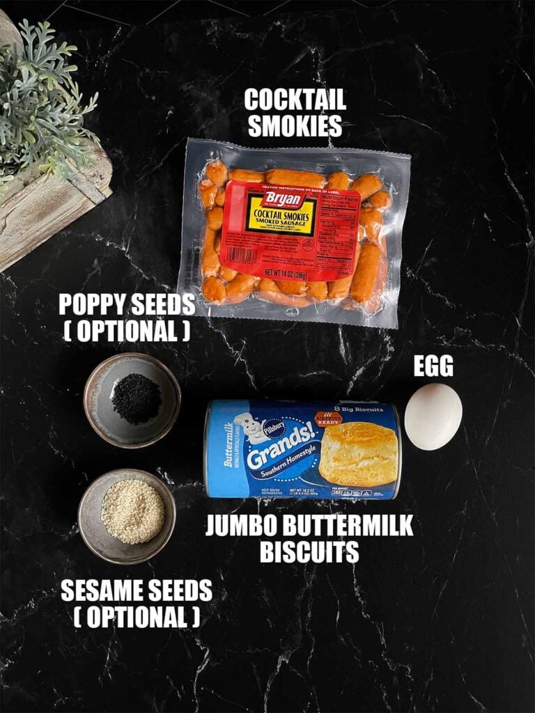 Ingredients for pigs in a blanket on a dark surface.