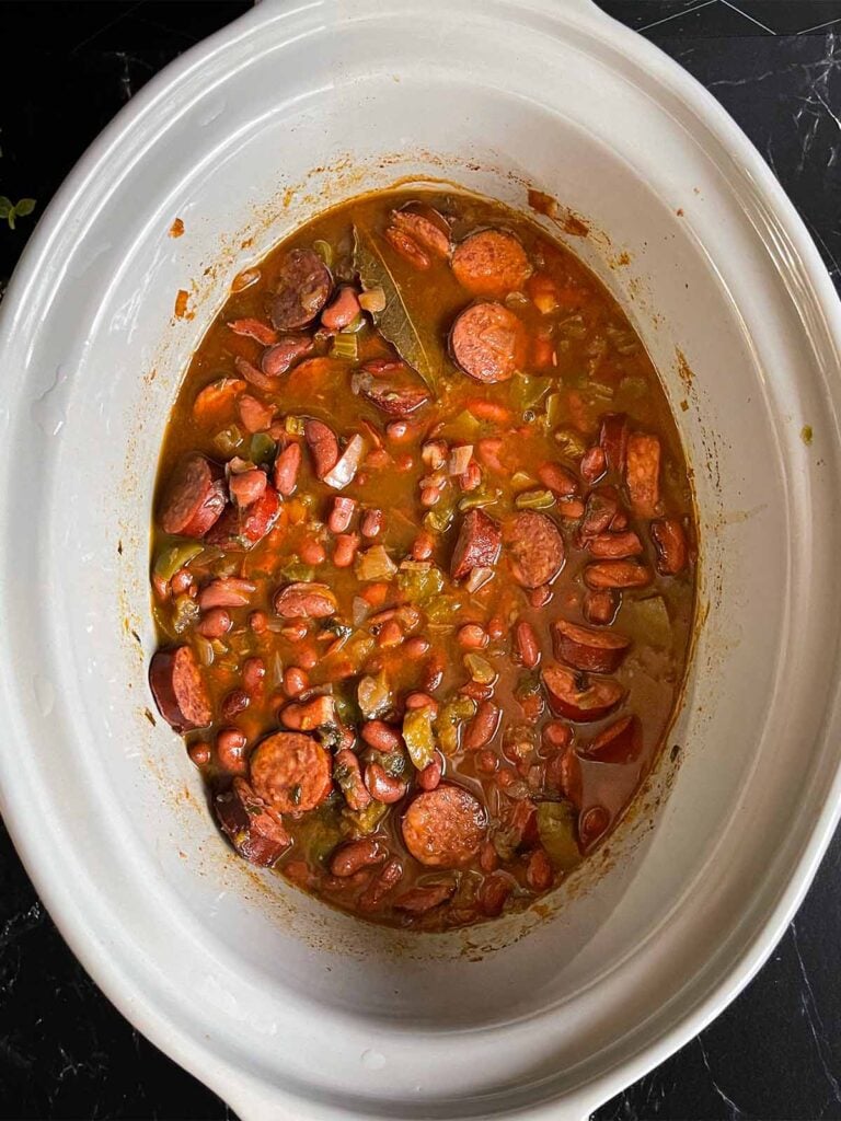 Cooked red beans in the crock of a slow cooker.