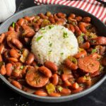 Slow cooker red beans and rice in a dark bowl on a dark surface.