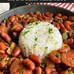 Slow cooker red beans and rice in a dark bowl on a dark surface.