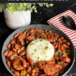 Slow cooker red beans and rice in a dark bowl on a dark surface.