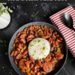 Slow cooker red beans and rice in a dark bowl on a dark surface.