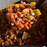 Slow cooker red beans and rice in ladle over the pot.