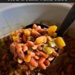 Slow cooker red beans and rice in ladle over the pot.