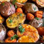 Roasted potatoes and carrots on a baking sheet.