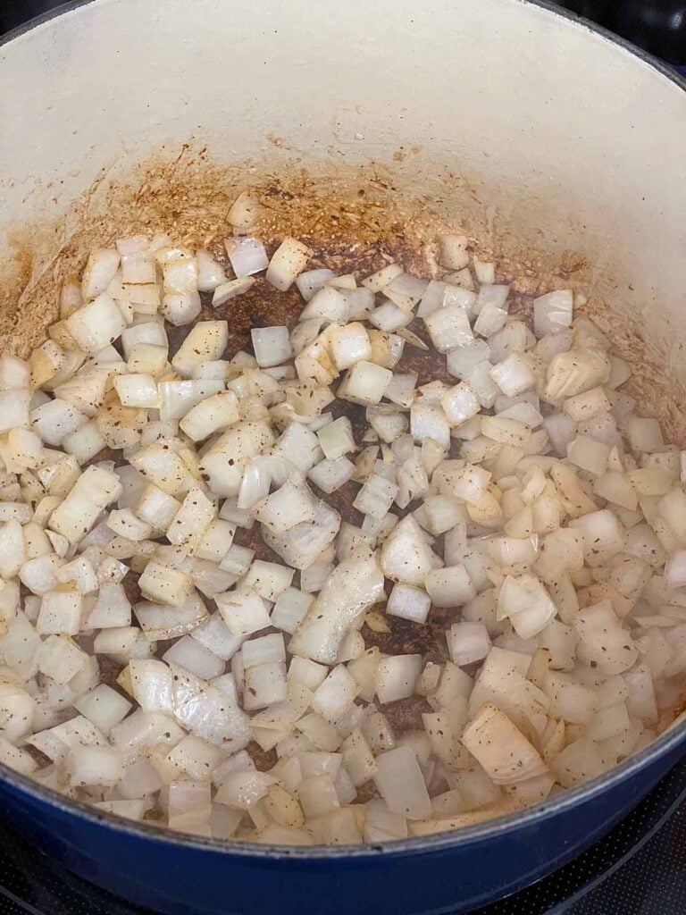 Onions cooking in a dutch oven.