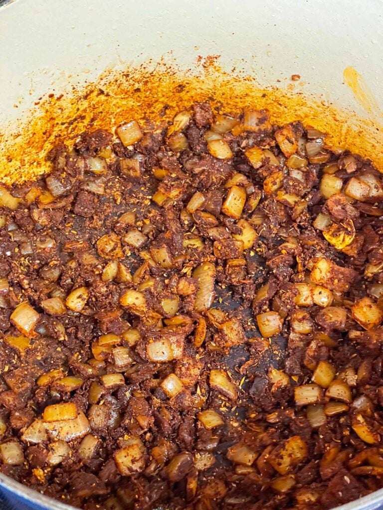 A brisket chili base (spices and onions) in a dutch oven.