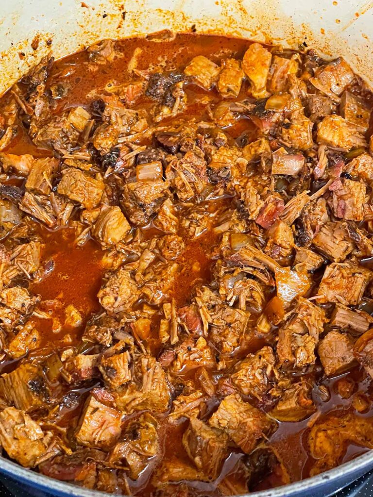 Brisket chili cooking in a dutch oven.