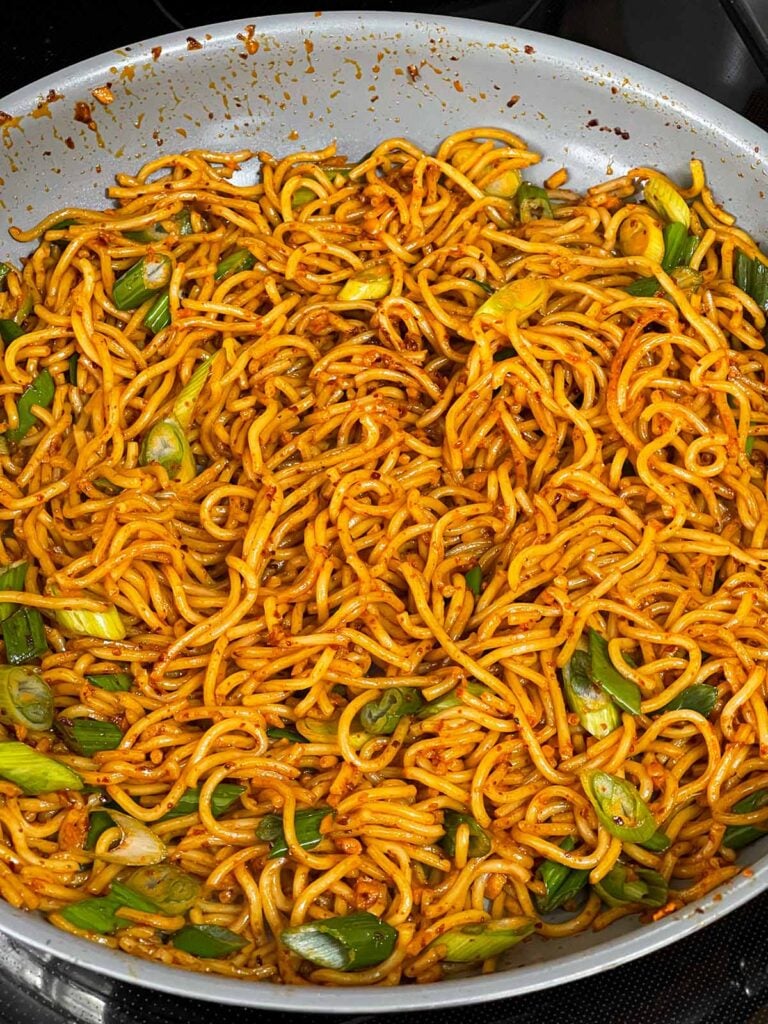 Spicy garlic noodles in a skillet.