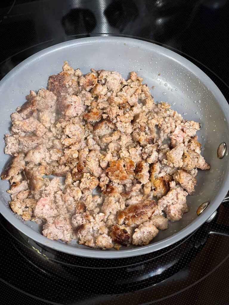 Browned sausage in a small skillet.