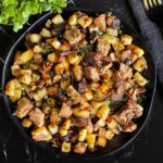 Smoked brisket hash on a dark plate.