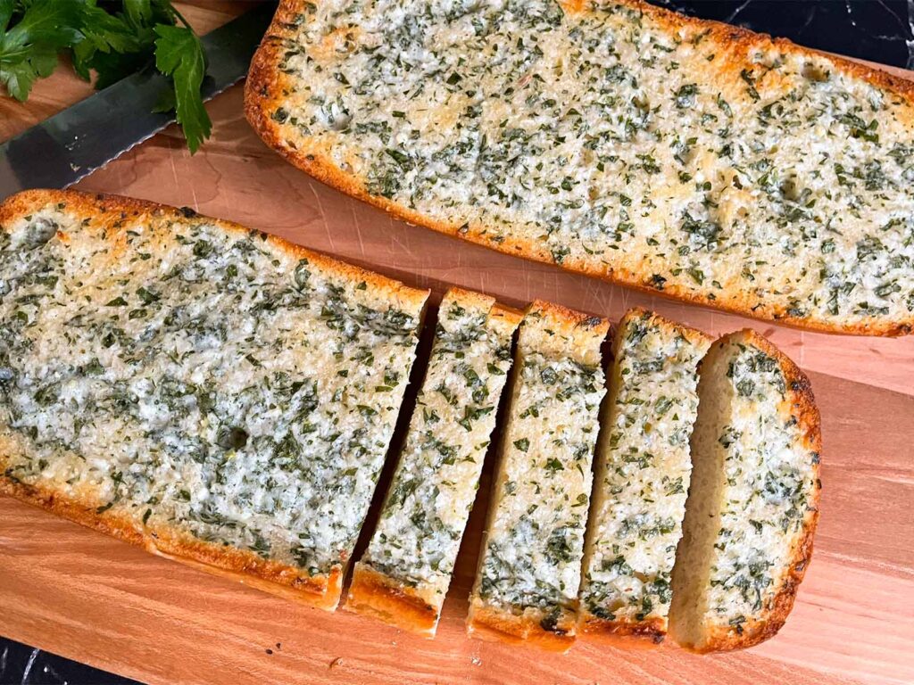 Garlic bread on a cutting board.