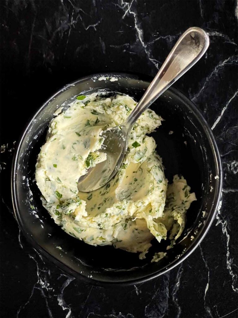 Compound butter in a black bowl.