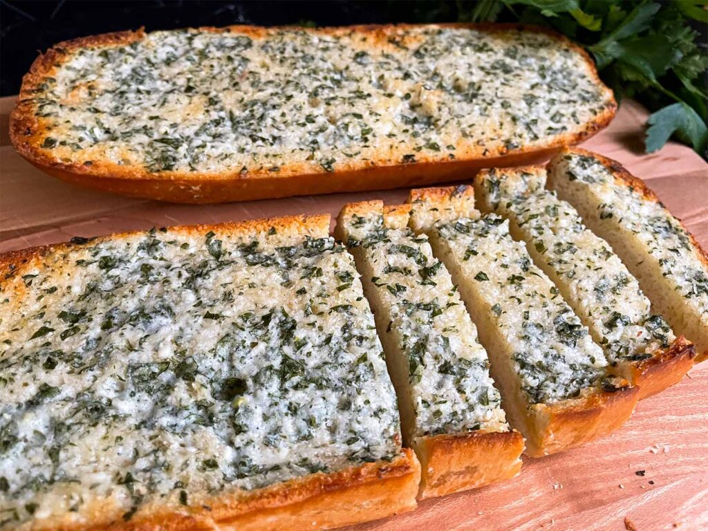 Garlic bread on a cutting board.