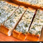 Garlic bread on a cutting board.