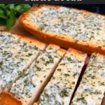 Garlic bread on a cutting board.