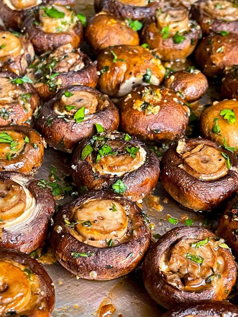 Garlic butter roasted mushrooms on a baking sheet.