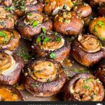 Garlic butter roasted mushrooms on a baking sheet.