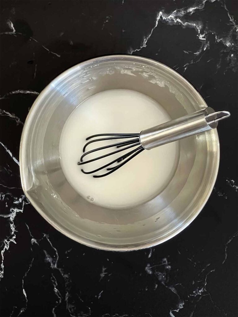 A cornstarch slurry in a small mixing bowl.