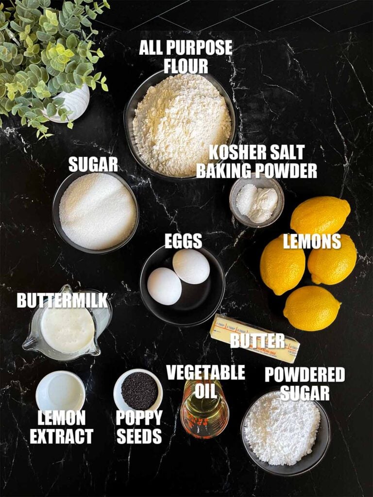 Lemon poppy seed muffin recipe ingredients on a dark surface.