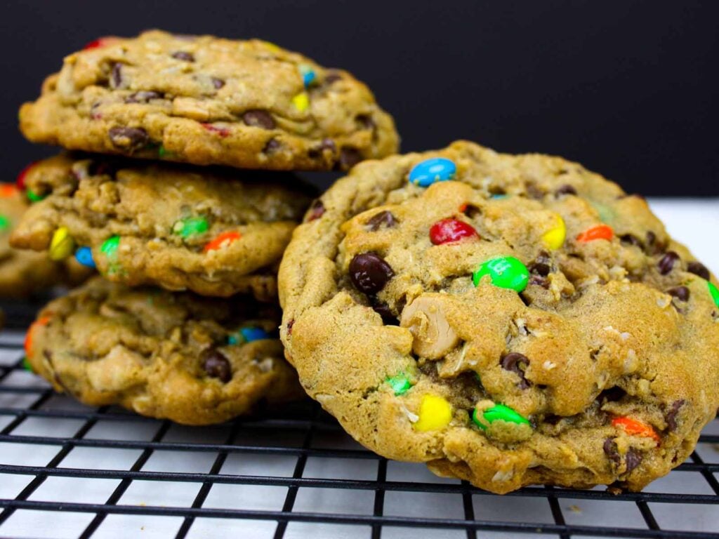 Monster cookies on a wire rack.