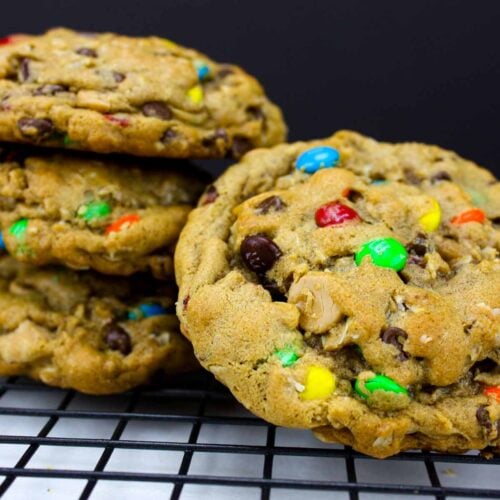 Monster cookies on a wire rack.