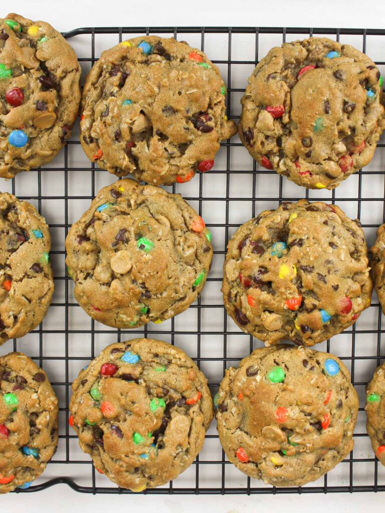 Monster cookies on a wire rack.